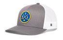 Introducing the Haka Hat St. Louis Hockey Trucker Hat | STL X Snapback— a classic gray and white mesh baseball cap from Haka Hat, featuring a blue circular patch with two crossed yellow hockey sticks, a puck, and the yellow letters S, T, and L. With its solid gray front panel and breathable white mesh sides and back, this snapback trucker hat delivers all-day comfort and is the perfect look for any St. Louis hockey fan.