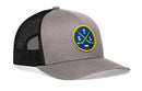 Show your St. Louis hockey pride with the Haka Hat St. Louis Hockey Trucker Hat | STL X Snapback by Haka Hat—a classic gray and black mesh snapback featuring a blue and yellow round patch with crossed hockey sticks, a puck, and “STL” on the front.