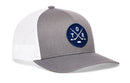 Show your love for Toronto hockey in style with the Haka Hat Toronto Hockey Trucker Hat | TOR X Snapback. This gray and white mesh-back cap from Haka Hat features a premium blue circular embroidered patch with crossed hockey sticks, a puck, and the letters T, O, and R—making it the perfect snapback trucker hat for true fans of the game.