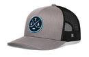 Grey and black Haka Hat Utah Hockey Trucker Hat | UTA X Snapback featuring a circular patch with the letters U T A, crossed hockey sticks, and a puck.