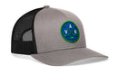 Grey and black Haka Hat Vancouver Hockey Trucker Hat | VAN X Snapback featuring a circular patch with the letters V, A, and N arranged around crossed hockey sticks and a puck.