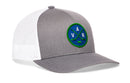 Gray and white Haka Hat Vancouver Hockey Trucker Hat featuring a circular patch with the letters V, A, and N arranged around crossed hockey sticks.