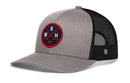 Haka Hat Washington DC Hockey Trucker Hat in grey and black, featuring a circular patch with crossed hockey sticks, a puck, and the letters W, S, and H.
