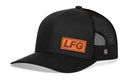 The Haka Hat LFG Trucker Hat in black features an orange patch with bold brown "LFG," a solid front, mesh sides, comfort-fit sweatband, and adjustable snapback for style and all-day comfort.