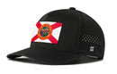 The Haka Hat Florida Flag Performance 5-Panel Hat features a state flag patch on the front, side ventilation holes, an H logo on the left, and a Flexfit® sweatband for comfort.