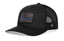 The Haka Hat Thin Blue Line Trucker Hat is a black police tactical snapback with a mesh back and an embroidered American flag patch featuring a blue line, honoring law enforcement.