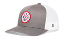 The Haka Hat USA Trucker Hat in gray and white features a mesh back, circular America patch with red border, crossed lines, USA letters, two stars, white side mesh, adjustable snapback, and a small branded tag.
