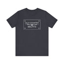 The Old Country BBQ Pits Vintage Logo T-Shirt by Printify is a dark gray tee with a white center logo, grill graphic, and scrolls—a perfect pitmaster shirt for barbecue fans.