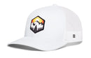 The Haka Hat Hexagon Mountain Trees Trucker Hat by Haka Hat is a white mesh snapback with a curved brim, featuring a front patch of mountains, trees, and a sunset in vibrant orange, yellow, and black—making it the ideal adventure hat for outdoor enthusiasts.