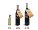 Three bottles of Georgetown Olive Oil Co. Honey Ginger White Balsamic—expertly crafted in the tradition of Modena, Italy—are available in 60ml, 200ml, and 375ml sizes. The two larger sizes from Georgetown Olive Oil Co. feature sleek black labels and tags, while the smallest comes in a clear, unlabeled bottle.