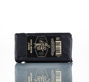 A black tin of beard balm from The Immaculate Beard, labeled “Conditioning Natural Beard Balm,” sits atop a reflective surface. Wrapped in dark packaging with the product name clearly displayed, it’s perfect for those who are dedicated to natural beard care—offering an essential step for both nourishing and styling beards. A barcode is present on the right side of the package.