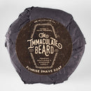 A round bar of The Immaculate Beard Immaculate Dense Shave Soap For Smooth Men Wet Shaving, expertly wrapped in black paper with a brown label, is the perfect choice for a traditional wet shave. Specially crafted for sensitive skin, it offers premium gentlemen’s grooming.