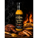 A bottle of Scott’s Smoked Q Carolina Gold Mustard BBQ Sauce for Pork, Chicken and Burgers—packed with bold, Southern-inspired flavor—sits among grilled chicken, corn on the cob, and a bowl of sauce, all set against the backdrop of a sizzling grill.