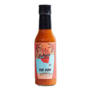 A bottle of Culture Hot Sauce The Don by Culture Hot Sauce, distinguished by its tropical-themed label depicting palm trees, water, and a small boat under an orange sky. This pineapple habanero hot sauce features an original recipe that brings bold, vibrant flavor to every drop.