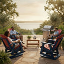 Four relax by the lake, drinks in hand, on a stone patio. They enjoy the outdoors from comfy Kanyon Living Adirondack Poly Glider Swivel Chairs in Red & Blue as a grill sizzles nearby and trees frame this sunny scene.