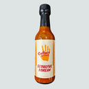 A bottle of Culture Hot Sauce Seoulful Korean from Culture Hot Sauce, featuring a red handprint logo on the front label. The orange-red color of this Korean hot sauce suggests its vibrant and bold flavor. The bottle is displayed against a plain light gray background.