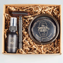 The Immaculate Beard presents the Immaculate Premium Wet Shaving Kit For Men, boxed with a ceramic bowl, natural shave soap, aftershave lotion, and a metal razor, all neatly arranged in shredded paper packaging.