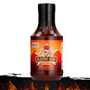A bottle of Blazing Star BBQ Spicy Sauce by Blazing Star BBQ, featuring an illustrated chef and flames on the label, sits against a fiery background with a black brushstroke—perfectly capturing the bold character of this flavorful BBQ sauce.