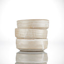 Three beige ceramic Shave Bowls by The Immaculate Beard, featuring subtle horizontal stripes, are stacked unevenly against a white background for a minimalist and modern look. Their matte finish and simple design create a handmade, rustic feel—perfect as a functional shave bowl for holding your favorite shave soap puck and building up a rich, moisturizing lather.