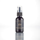 A small dark bottle from The Immaculate Beard’s Shave Gift Set, labeled Bright After Shave Lotion and topped with a black spray cap, stands on a white reflective surface against a plain white background—ideal for completing your grooming routine after using natural shave soap or as part of a traditional hot shave experience.