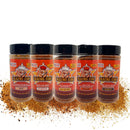 Five Blazing Star BBQ seasoning bottles are lined up with spilled seasoning beneath them. The labels read Scorpion, All In One, Reaper, and Pork—and each bottle displays the signature cartoon chef logo—making the Blazing Star BBQ Ultimate Seasoning Bundle the perfect choice for anyone after bold flavors and MSG-free seasonings.