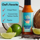 A bottle of Culture Hot Sauce Tahitian Dream sits next to a halved coconut and limes. A sign reads: Chef’s Favorite: Unique Flavor, Coconut Lime Tahitian Vanilla, Popular. This tropical hot sauce from Culture Hot Sauce blends zesty coconut lime with smooth Tahitian vanilla for an unforgettable taste experience.