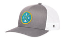 Black Jacksonville trucker hat by Haka Hat, featuring a round blue and yellow JAX X embroidered patch with crossed lines and a small football icon on the front.