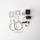 The Flame Boss 400 WiFi Kamado Smoker Controller Kit (FB400-K) by Flame Boss offers precise temperature control for Kamado grills and includes a controller unit, power adapter, two metal probes, a mounting bracket, and three plates with square cutouts.