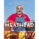 A smiling man in a red shirt and blue apron stands at a grill. In his hands is the hardcover edition of "Meathead: The Science of Great Barbecue and Grilling" by Books by splitShops, featuring images of perfectly grilled meat on the cover. This definitive guide by Meathead Goldwyn delves into the science behind barbecue, making it an essential resource for grilling enthusiasts.