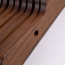Close-up of the Messermeister In-Drawer Knife Holder - 11 Slot, featuring smooth grooves and a small round hole. The rich brown finish showcases this finely crafted Messermeister organizer, perfect for keeping knives neatly stored.