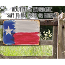 The Texas Flag - Metal Sign by Lone Star Art hangs on a wooden gate, surrounded by grass and wildflowers. Durable, beautiful, and affordable, this sign is perfect for both indoor and outdoor use.