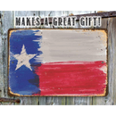 The Lone Star Art Texas Flag - Metal Sign hangs on a wooden fence. "MAKES A GREAT GIFT!" appears above in bold, distressed letters. Proudly made in the USA for lasting quality.