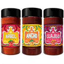 Introducing the Rico Rico Chile Powder 3 Pack Bundle, featuring jars of Ancho, Guajillo, and Arbol chile powders. Each jar by Rico Rico comes with a vibrant swirly label and an illustrated pepper character, topped with a black lid and filled with rich reddish-brown powders. This authentic bundle is an essential for anyone passionate about Mexican cuisine—perfect for adding bold flavor to your favorite dishes.