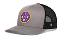 The Haka Hat Minnesota Trucker Hat is a black snapback featuring a purple and yellow MIN X football patch—ideal for game day style.