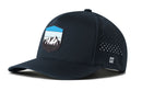 Introducing the Haka Hat Mountains and Sky Performance 5-Panel Hat, an Outdoors Flexfit Snapback in dark blue featuring a curved brim, moisture-wicking mesh sides, and a mountain-and-tree patch on the front in blue, white, and black. A small Haka Hat logo accents the left side near the brim.
