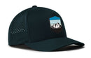 The Haka Hat Mountains and Sky Performance 5-Panel Hat by Haka Hat is a dark-colored, moisture-wicking outdoors Flexfit snapback featuring ventilation holes on the sides and a front patch with stylized mountains and a blue sky.