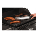 Using metal tongs, someone grills sausages and burger patties on a black outdoor gas grill equipped with the Napoleon Enameled Cast Iron Reversible Griddle for Rogue 365/525 Model Grills by Napoleon Grills (56365).