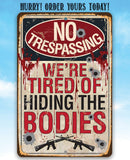 The No Trespassing Tired of Hiding The Bodies - Metal Sign by Lone Star Art features bullet holes, blood spatters, and rifle graphics—a bold gun-themed decor piece with dark humor. Order yours today!.