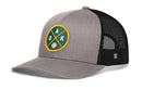 The Haka Hat Oakland Baseball Trucker Hat | OAK X Snapback features gray and black mesh with a green and yellow circular patch displaying “OAK,” two bats, and a baseball on the front—an ideal addition to any Oakland baseball hat collection.