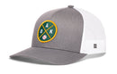 The Haka Hat Oakland Baseball Trucker Hat | OAK X Snapback by Haka Hat features a classic trucker hat design in gray and white, highlighted with a green and yellow patch on the front that displays crossed bats, the letters “OAK,” and a baseball. This snapback includes a white mesh back for breathable comfort.