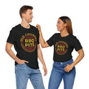 Unisex BBQ t-shirt worn by man and woman grilling together – premium fit, available at DDR BBQ Supply