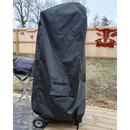 A covered grill stands on a wooden deck protected by the Old Country BBQ Pits Vertical Smokehouse Cover - Heavy Duty. The fenced backyard features grass, bare trees, and a decorative red sign mounted on the fence.