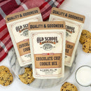 Old School Brand chocolate chip cookie mix packages on a marble surface with cookies and a glass of milk.