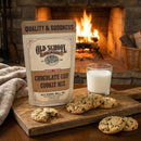 Old School Brands chocolate chip cookie mix package with cookies and milk in front of a fireplace.