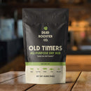 A bag from the Dead Rooster Co. Variety Pack - 3 Signature BBQ Rubs Bundle & Save rests on a wooden table. The green and cream packaging by Dead Rooster Co. lists various meats and veggies it’s perfect for, making it an excellent choice for anyone looking to expand their collection of BBQ rubs.