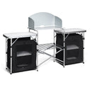 The DirectDeals Folding Camping Table with Storage Organizer features two side tables, mesh storage cabinets, a central metal rack shelf, and a back windscreen—your perfect camping table with storage.
