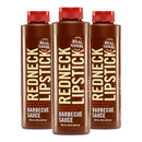 Three bottles from the Redneck Lipstick Original Smoky Sweet & Spicy BBQ Sauce - 3 Pack by Redneck Lipstick, featuring brown labels with bold white text and red caps, are arranged side by side on a white background.