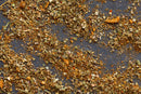 A close-up view of World Spice Pacific Seafood, a blend from World Spice featuring curry lemongrass and a hint of seafood rub, scattered on a dark surface.