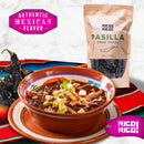 A bowl of Mexican soup with avocado and tortilla strips is set among authentic Rico Rico Pasilla Dried Chiles – Mild & Rich Mexican Chile Negro from Oaxaca, a striped cloth, and a pack of Rico Rico pasilla dried chiles on a marble background. Text reads “Authentic Mexican Flavor.”.