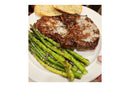 A plate with grilled asparagus spears drizzled with Terrapin Ridge Pecan Honey Mustard from Terrapin Ridge Farms, a seasoned steak topped with grated cheese, and two slices of garlic bread.